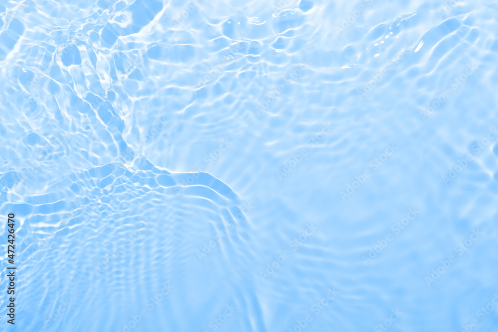 Fresh water background. Bright blue pattern with natural rippled water texture. Top view with copy space. Cosmetic water surface background. Moisturizing, hydration concept