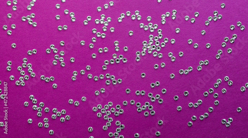 rhinestones on a purple background, top photo. design for text