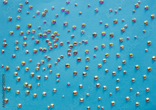rhinestones on a blue background, top photo. design for text