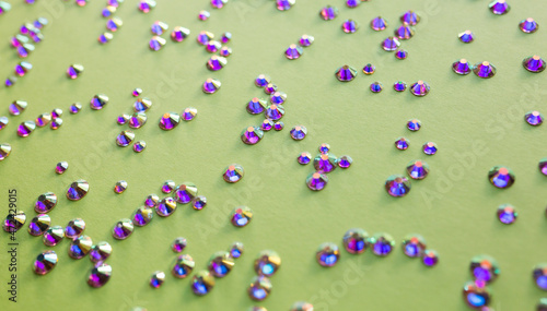 rhinestones on a green background,blure. design for text