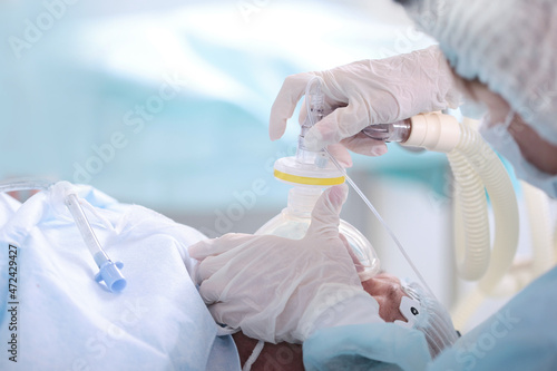 General anesthesia before surgery. Medical anesthesia. Preparing for surgery. Life saving. The anesthesiologist holds a breathing mask. Donation concept.Copy space. photo