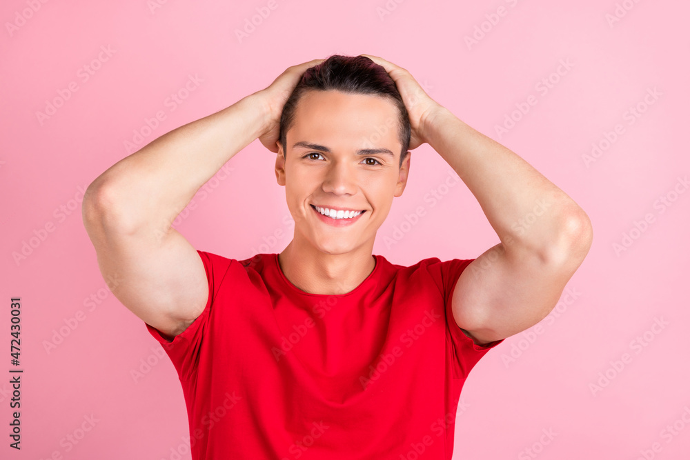 Photo of attractive adorable young guy dressed red t-shirt hands arms head smiling isolated pink color background Photo of attractive adorable young guy dressed red t-shirt hands arms head smiling isolated pink color background