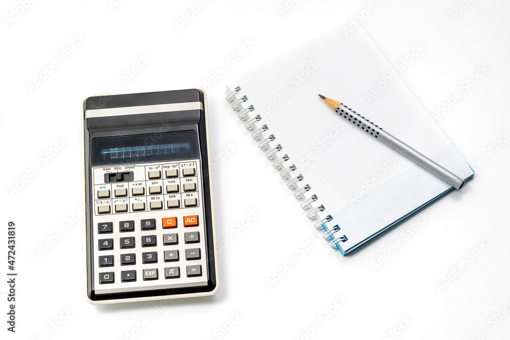 Calculator, pencil and notebook on white background. Close-up. Copy space Calculator, pencil and notebook on white background. Close-up. Copy space