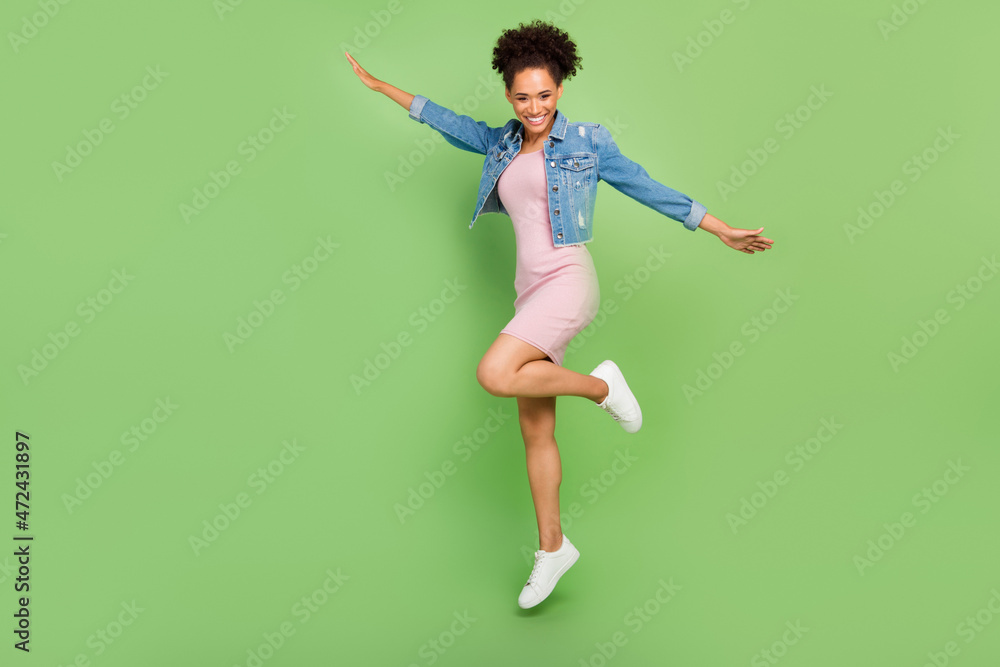 Full size photo of funny millennial lady jump wear dress shirt sneakers isolated on green background Full size photo of funny millennial lady jump wear dress shirt sneakers isolated on green background