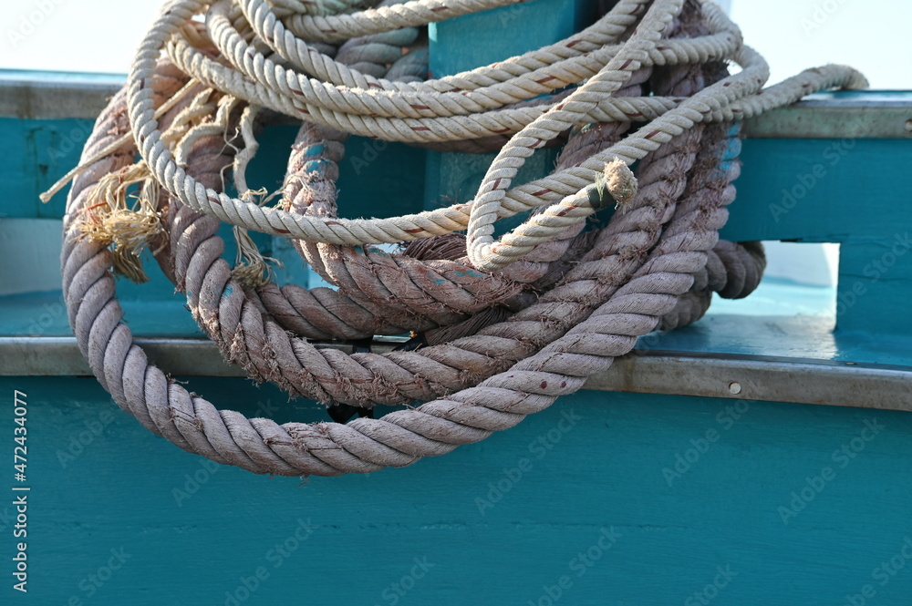 Different sizes manila or polypropylene rope is wrapped neatly to the pole inside the boat. The end of the rope is tied with black plastic to prevent damage to the rope during use. used tying boat
