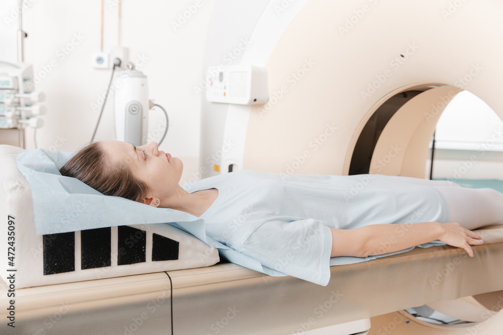 Medical CT or MRI Scan with a patient in the modern hospital laboratory. Interior of radiography department. Technologically advanced equipment in white room. Magnetic resonance diagnostics machine Medical CT or MRI Scan with a patient in the modern hospital laboratory. Interior of radiography department. Technologically advanced equipment in white room. Magnetic resonance diagnostics machine