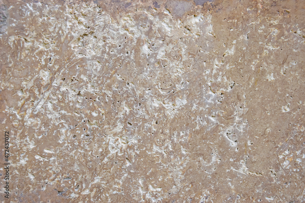 Horizontal brown polished stone texture with abstract pattern, design background. Copy space. Selective focus.