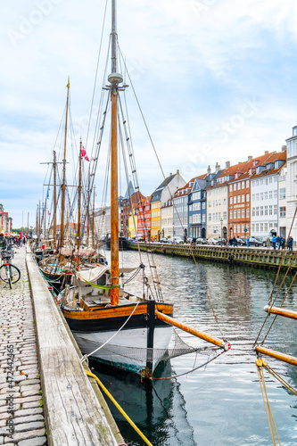 Copenhagen, Denmark - October 1, 2021: view of Nyhavn pier with colorful buildings and boats in Old Town of Copenhagen