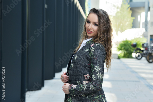 Businesswoman in Poland. Portrait of young office lady with modern building as background.