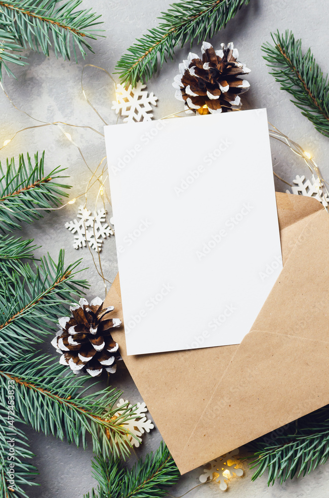 Christmas greeting card mockup with envelope and fir tree with cones and garlands Christmas greeting card mockup with envelope and fir tree with cones and garlands