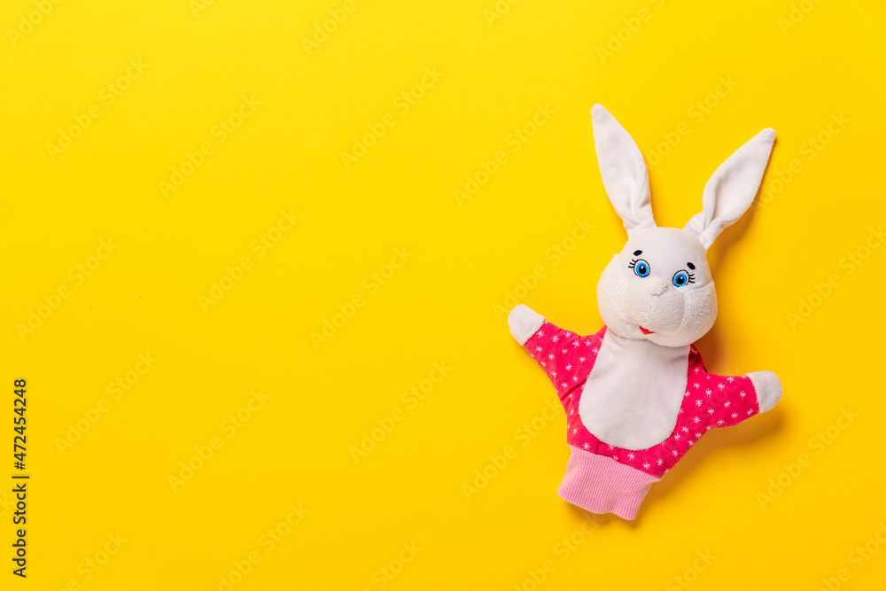 Obraz premium Banner with Easter bunny isolated on yellow background with copy space, empty text place. Education toy theater online course. Hand puppet. Sewing hobby. Fairy tale character. Fluffy baby play friend