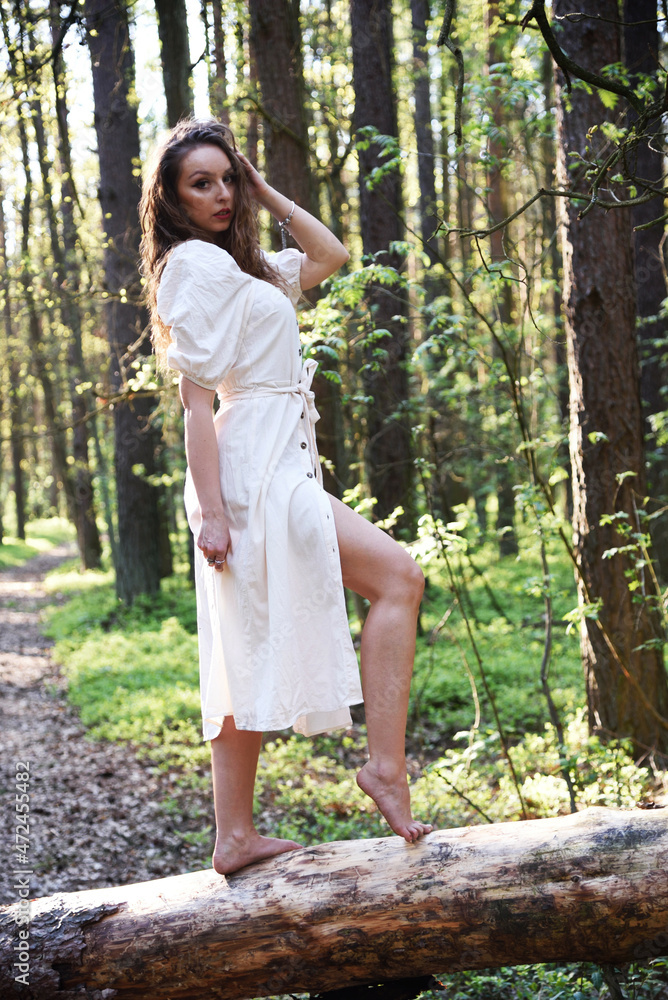 Pretty, young woman posing in the forest with her legs uncovered. Green surroundings during spring in Poland. Pretty, young woman posing in the forest with her legs uncovered. Green surroundings during spring in Poland.