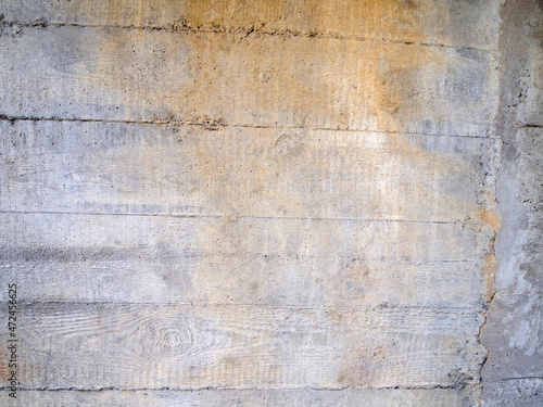 Gray concrete background with rough surface and brown stain. Wood texture.