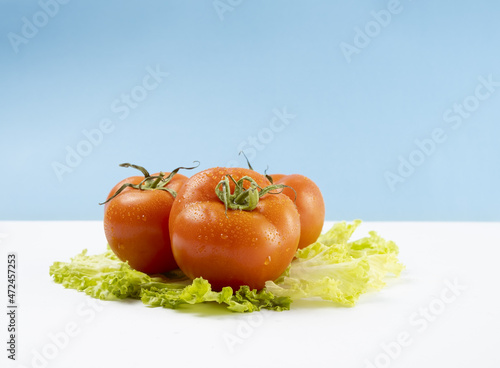 fresh tomatoes on green lettuce