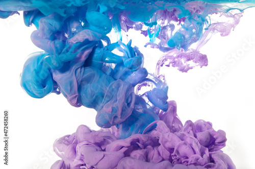 Blue and purple ink in water isolated on white background, beautiful delicate background