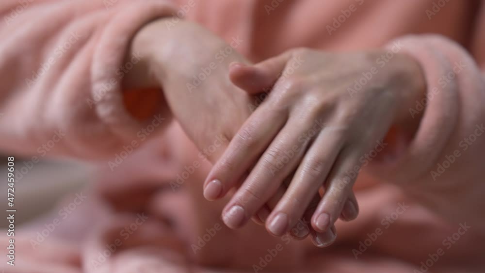 Close-up young female hands rubbing hand cream in slow motion. Unrecognizable Caucasian woman applying skin moisturizer at home indoors in the morning. Pampering and femininity concept Close-up young female hands rubbing hand cream in slow motion. Unrecognizable Caucasian woman applying skin moisturizer at home indoors in the morning. Pampering and femininity concept