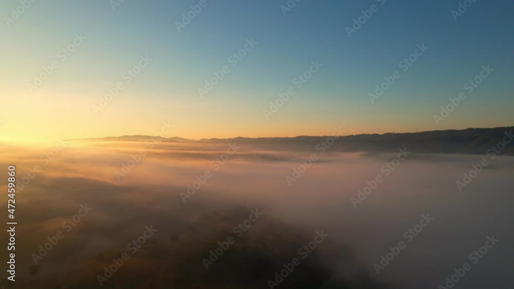 4K Drone Flying through the clouds at dusk or dawn. Aerial top cloudscape view from drone. Tropical forest with smoke and fog.
4K Drone Flying through the clouds at dusk or dawn. Aerial top cloudscape view from drone. Tropical forest with smoke and fog.