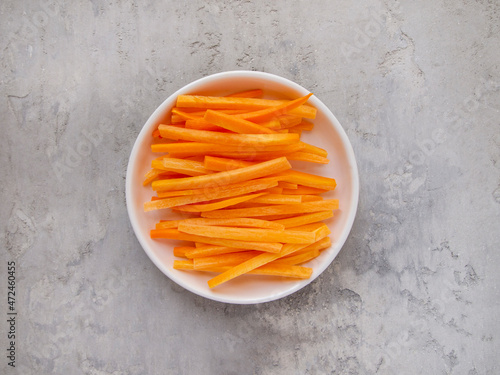 Julienne carrot on a white plate.