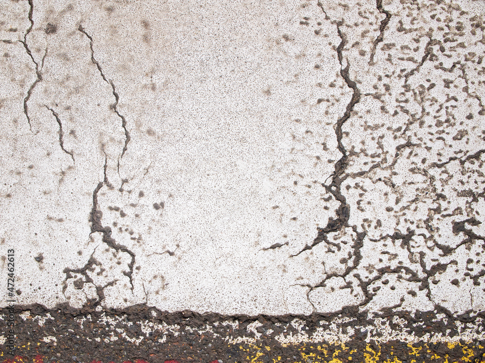 Obraz premium Asphalt in white paint. The surface is damaged and cracked. Abstract background.