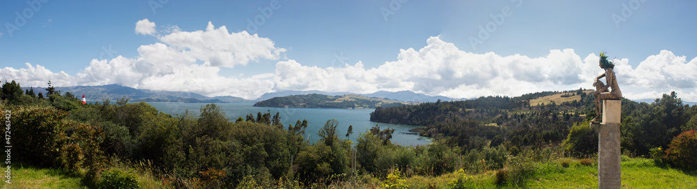 Colombian Tota lake landscape with indigenous golden sculpture at sunny day