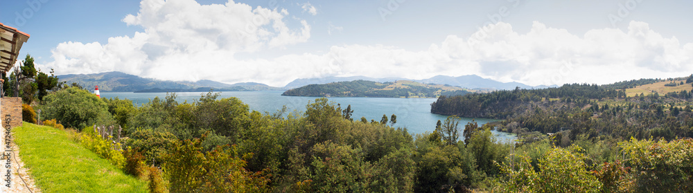 Beautiful Colombian Tota lake panoramic photography with forest and andean mountains at background in sunny midday