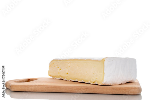 One fragrant piece of brie cheese on a wooden board, close-up, isolated on white.