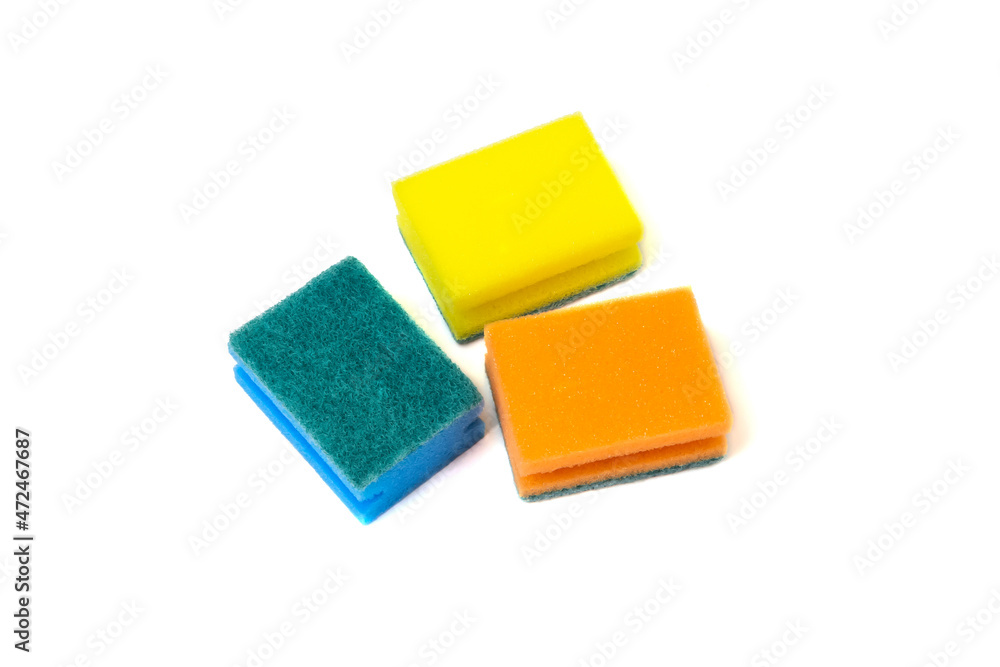 Dishwashing sponges of different colors on a white background. Close-up. Copy space. Dishwashing sponges of different colors on a white background. Close-up. Copy space.
