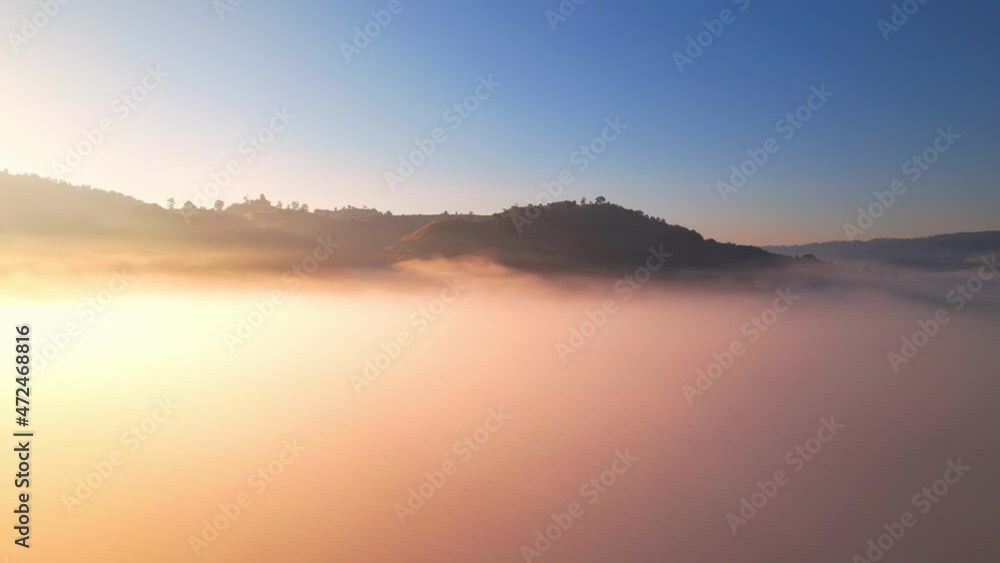 4K Drone Flying through the clouds at dusk or dawn. Aerial top cloudscape view from drone. Tropical forest with smoke and fog.
4K Drone Flying through the clouds at dusk or dawn. Aerial top cloudscape view from drone. Tropical forest with smoke and fog.