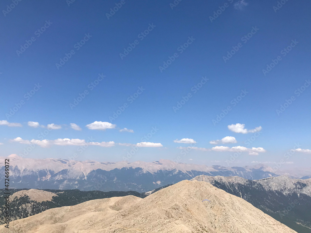Fototapeta premium Beautiful landscape view from a high mountain to the forest and mountains in a tropical country with resorts and the sea