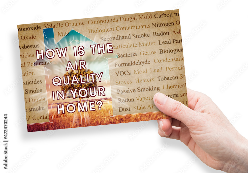 Fototapeta premium HOW IS THE AIR QUALITY IN YOUR HOME? - concept with the most common dangerous domestic pollutants in our homes and hand holding a postcard
