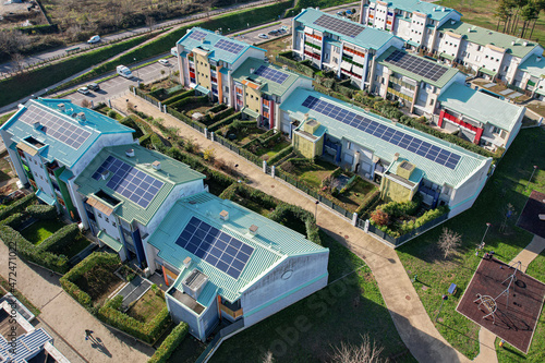 Modern houses with solar panels on the roof for alternative energy. Grugliasco, Italy - November 2021 photo