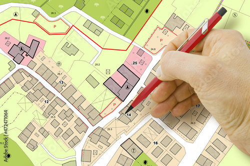 Engineer drawing over an imaginary General Urban Plan of territory with buildings, roads and land parcel - note: the map is totally invented and does not represent any real place