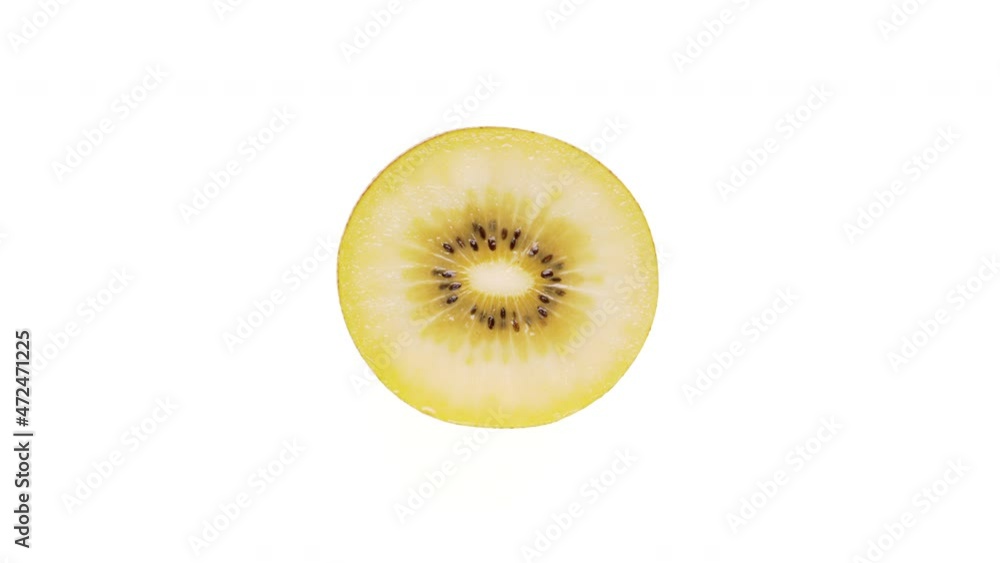 Top view of a yellow kiwi fruit cross-section cut rotating. Isolated on white background. Close-up. Top view of a yellow kiwi fruit cross-section cut rotating. Isolated on white background. Close-up.