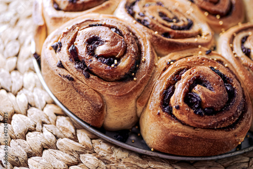 Homemade cinnamon rolls made from yeast dough, Chelsea rolls with cinnamon and raisins. Homemade snail buns close-up. Do-it-yourself authentic buns