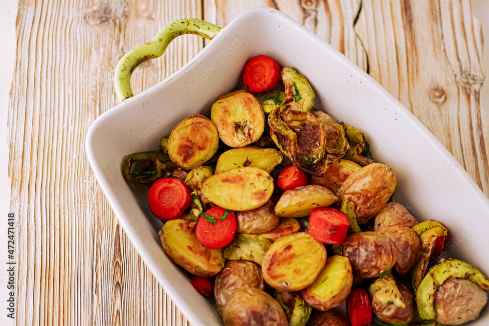 Oven baked vegetables in a baking dish. Vegetable dish close-up. Assorted vegetables roasted with spices, vegan recipe, copy space Oven baked vegetables in a baking dish. Vegetable dish close-up. Assorted vegetables roasted with spices, vegan recipe, copy space