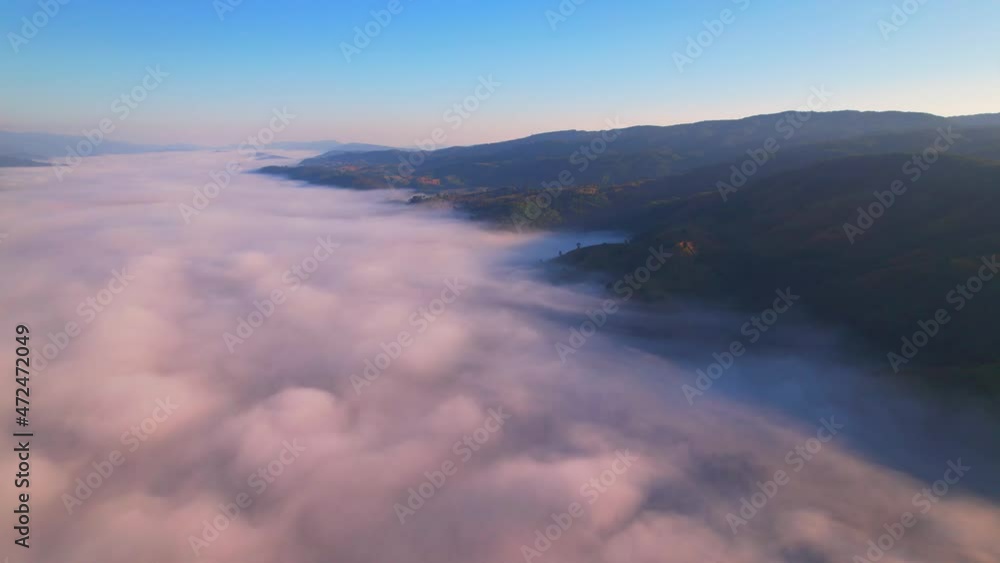 4K Scenic flight over beautiful mountain scape with bright sky and fog clouds on summer sunrise. Flight above clouds
4K Scenic flight over beautiful mountain scape with bright sky and fog clouds on summer sunrise. Flight above clouds