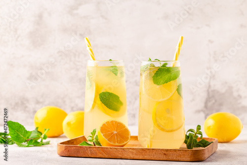 Lemonade with lemon, mint and ice cubes in glass