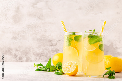 Lemonade with lemon, mint and ice cubes in glass