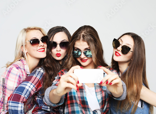 happy teenage girls with smartphone taking selfie