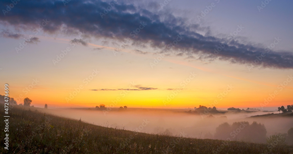 Foggy landscape at sunrise
