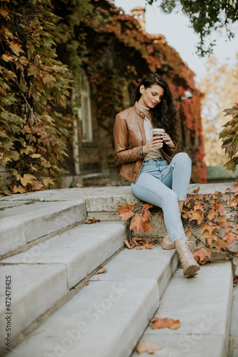 Young woman drinking takeaw...