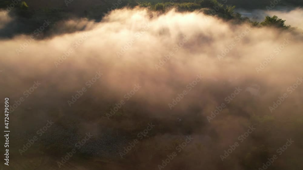 4K Drone Flying through the clouds at dusk or dawn. Aerial top cloudscape view from drone. Tropical forest with smoke and fog.
4K Drone Flying through the clouds at dusk or dawn. Aerial top cloudscape view from drone. Tropical forest with smoke and fog.