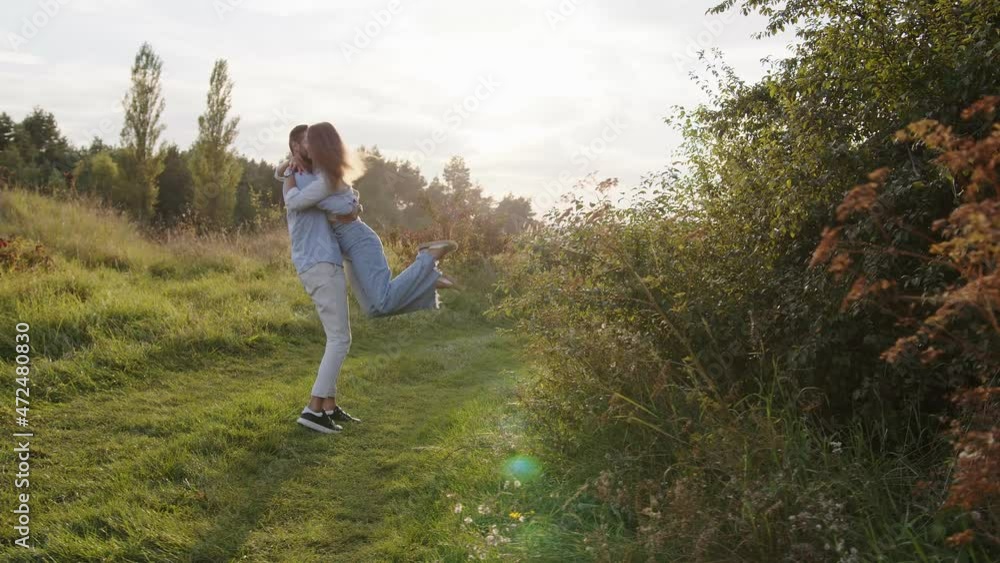 Romantic couple walking in park. Portrait of happy man and woman spending time and hugging at summer outdoors. Romantic couple walking in park. Portrait of happy man and woman spending time and hugging at summer outdoors.