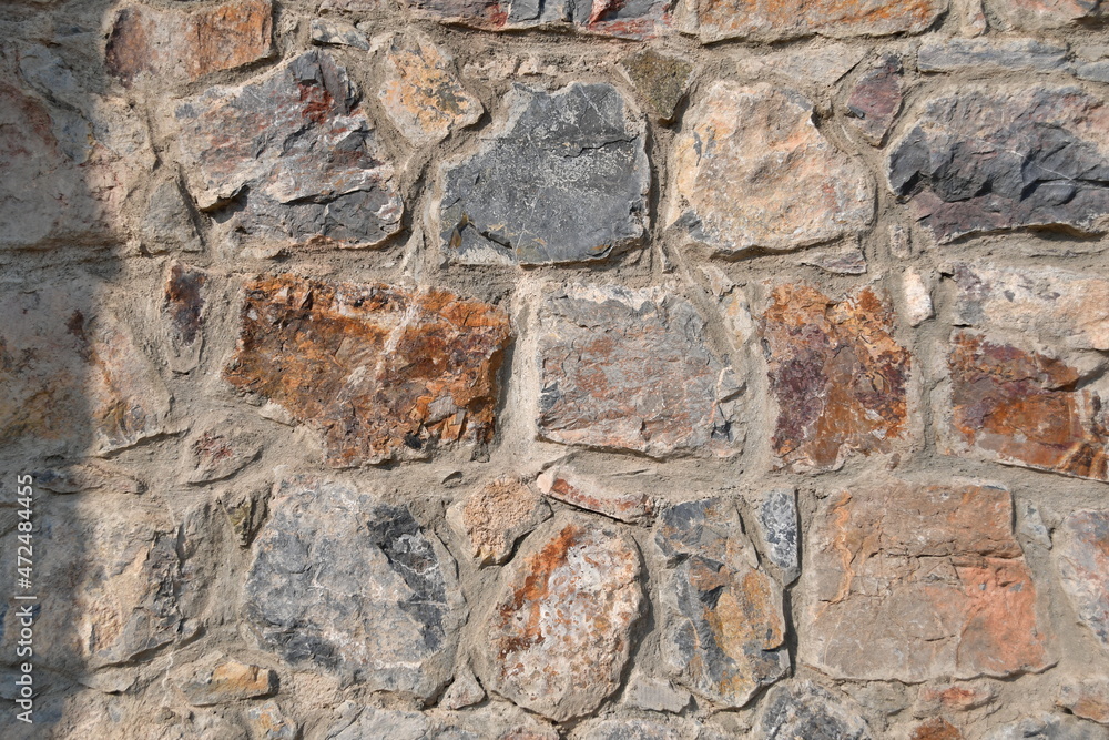 Background, texture of natural stone. A wall of large cut stones.