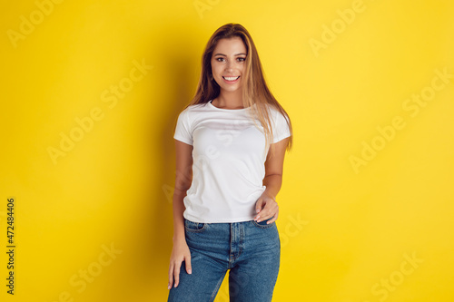 Pretty woman with long hair wearing a white t-shirt. Mock-up.