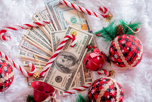 Money paper dollars on a white background with Christmas props. New year and christmas, finance.