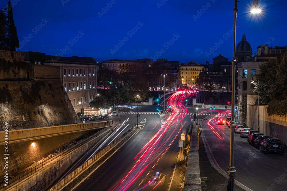 Fototapeta premium Cool long exposure bus traffic neon blue-orange light trails, night view on the street road, Rome, Italy 