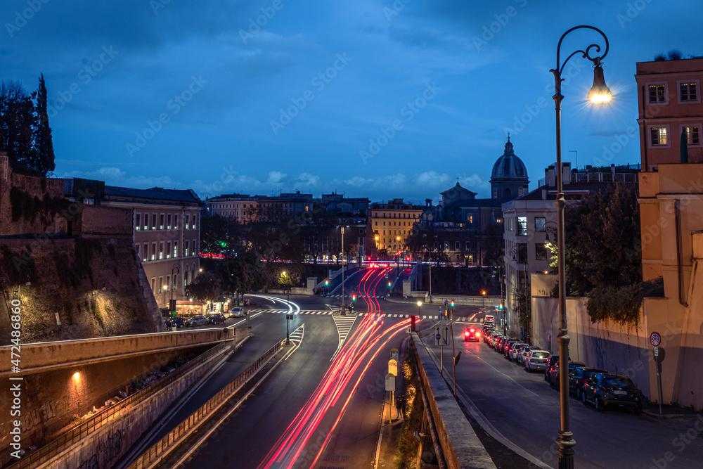 Cool long exposure bus traffic neon blue-orange light trails, night view on the street road, Rome, Italy
