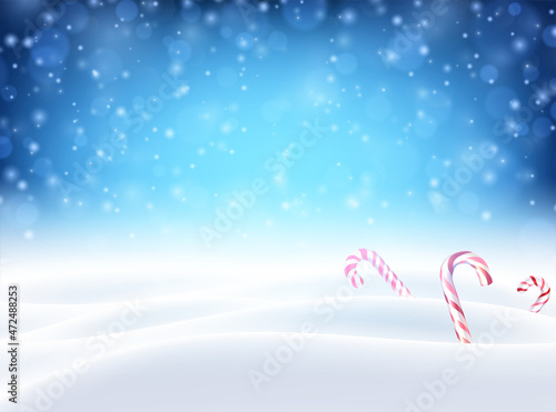Christmas candy canes on snowy background.