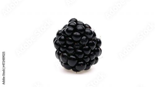 Closeup of one blackberry isolated. Rotating on white background. Macro.